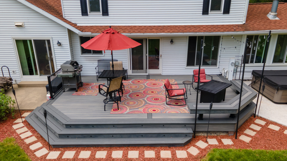 Mid-sized transitional backyard metal railing deck photo with a bbq area