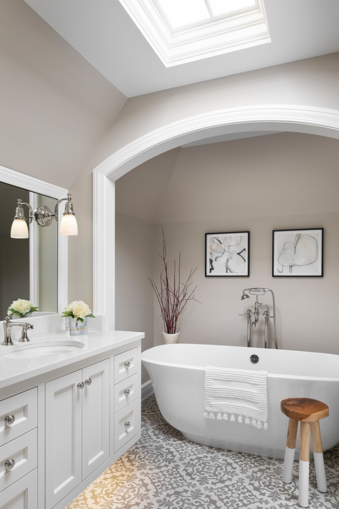 Transitional master bathroom in Milwaukee with a freestanding tub.