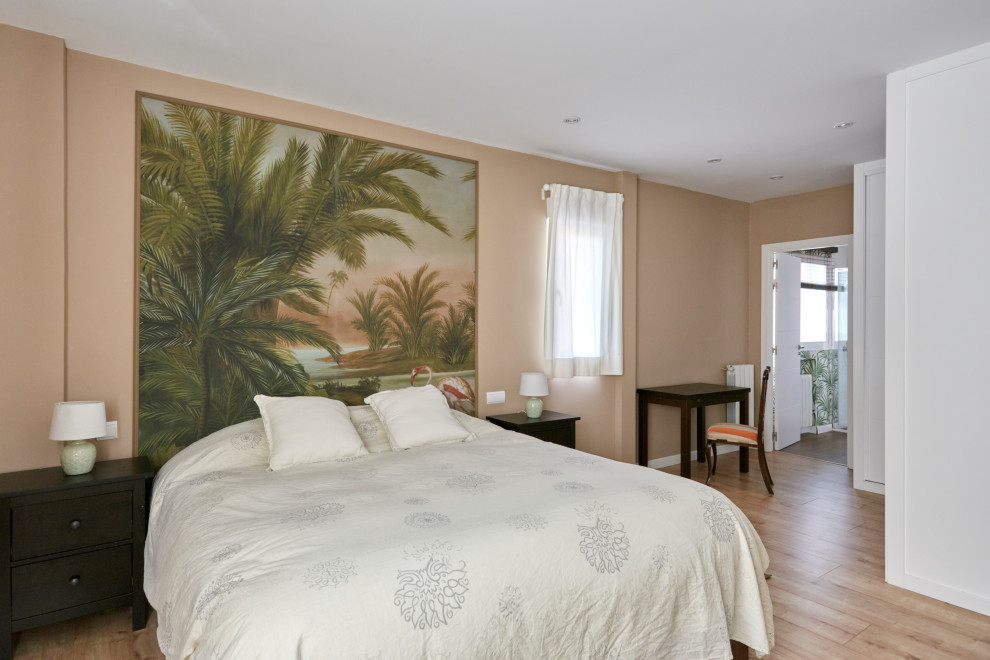 Large master medium tone wood floor bedroom photo in Madrid with beige walls