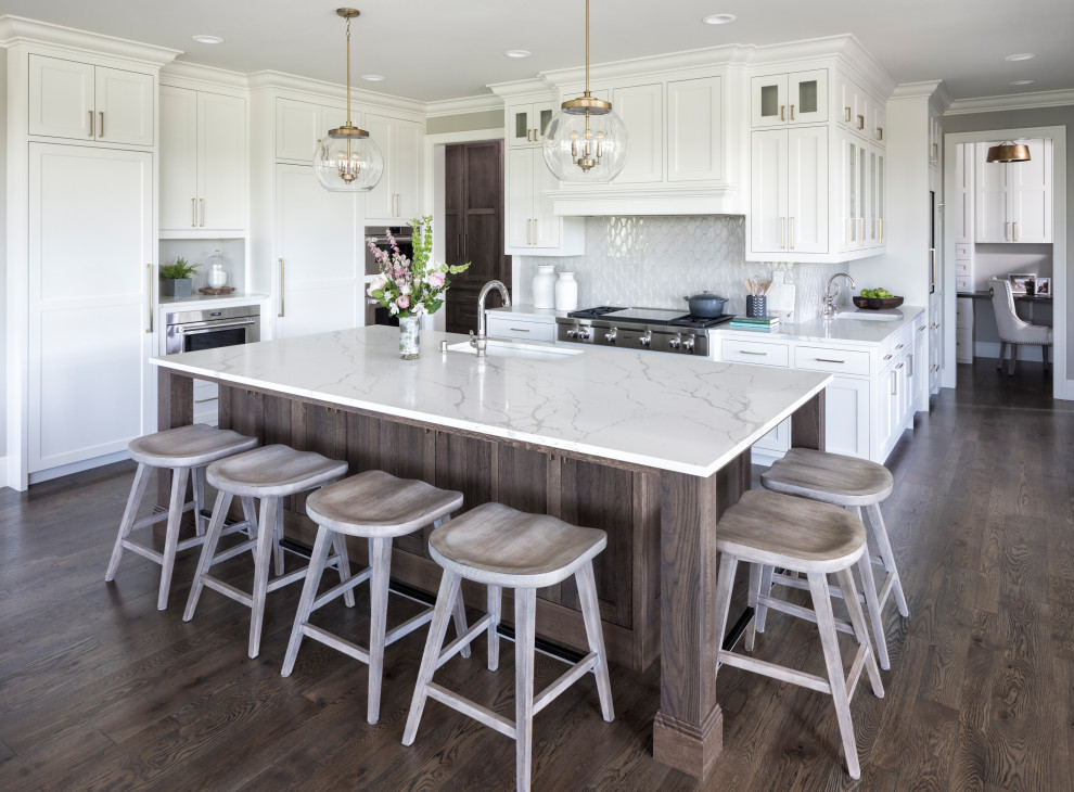 Inspiration for a transitional u-shaped open plan kitchen in Minneapolis with an undermount sink, shaker cabinets, white cabinets, marble benchtops, grey splashback, panelled appliances, medium hardwood floors, with island, brown floor and grey benchtop.