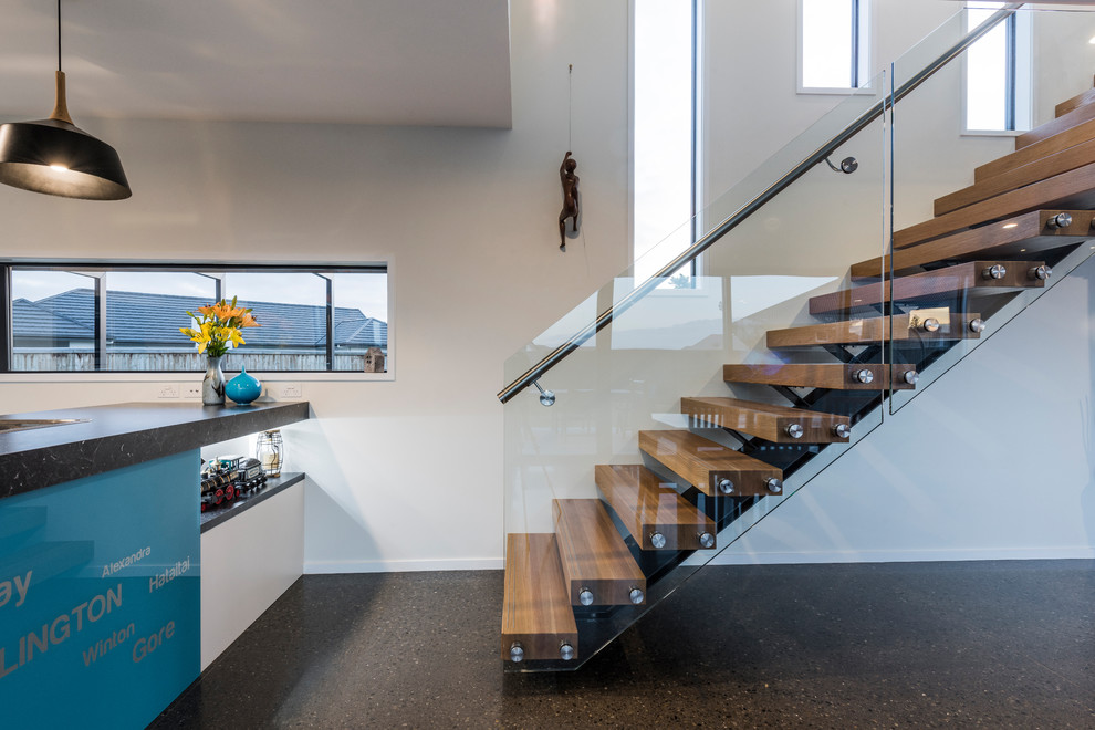 Contemporary wood staircase in Other with open risers.