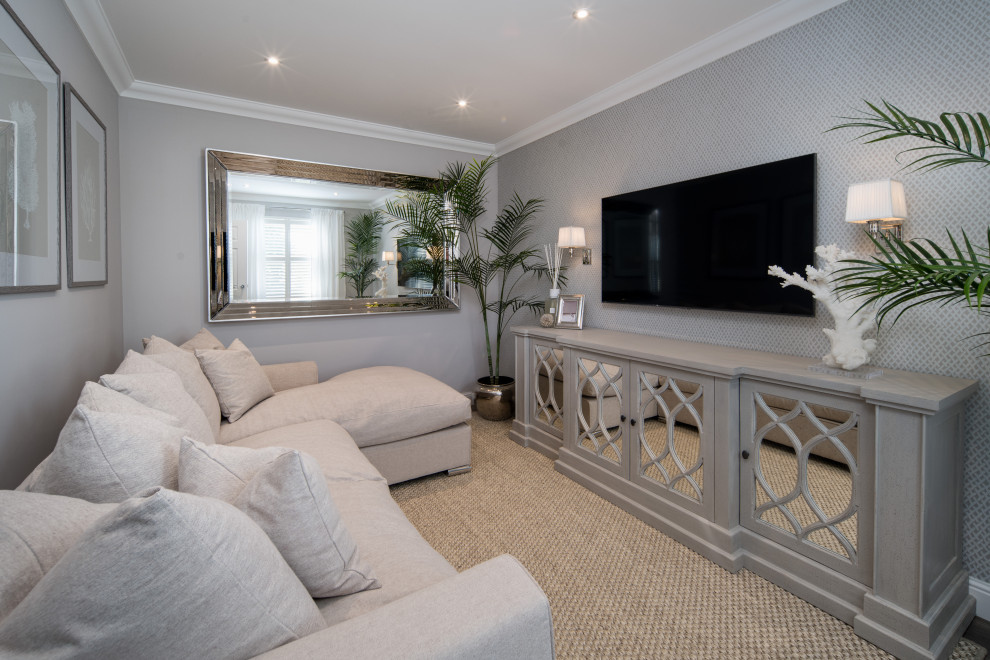 На фото: изолированная гостиная комната среднего размера в морском стиле с серыми стенами, полом из ламината, телевизором на стене, коричневым полом и обоями на стенах без камина