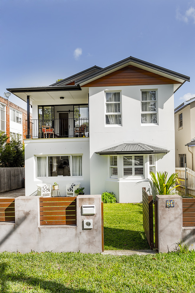 This is an example of a large scandinavian two-storey stucco white exterior in Sydney with a gable roof.