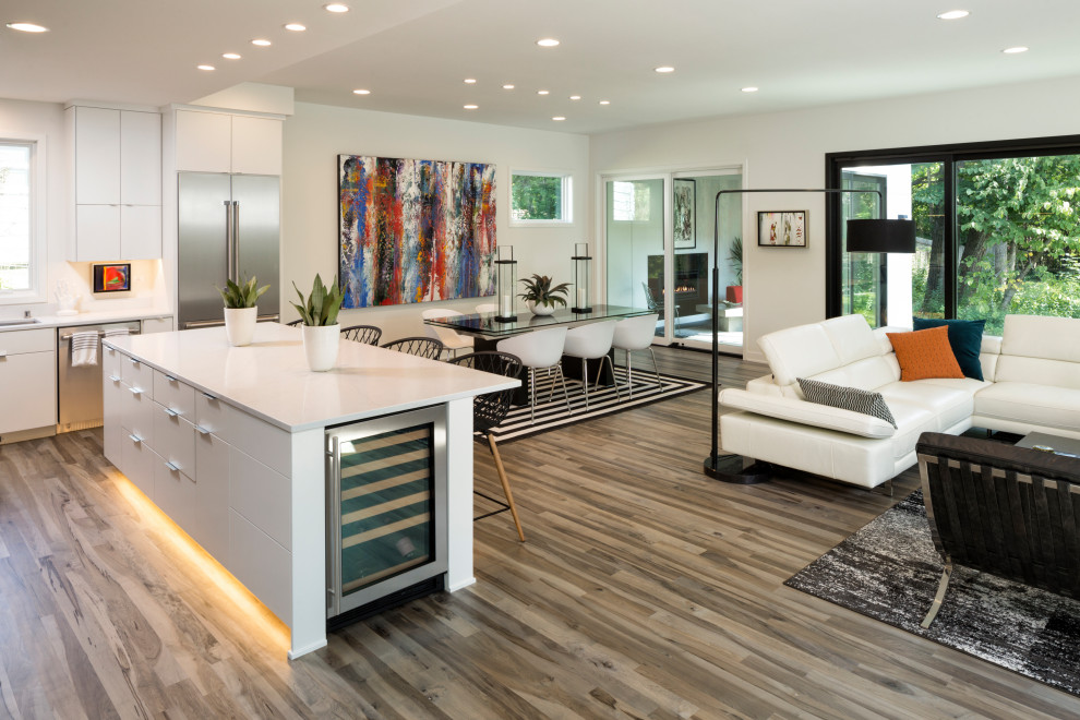 Photo of a large modern kitchen/dining combo in Minneapolis with white walls, medium hardwood floors and grey floor.