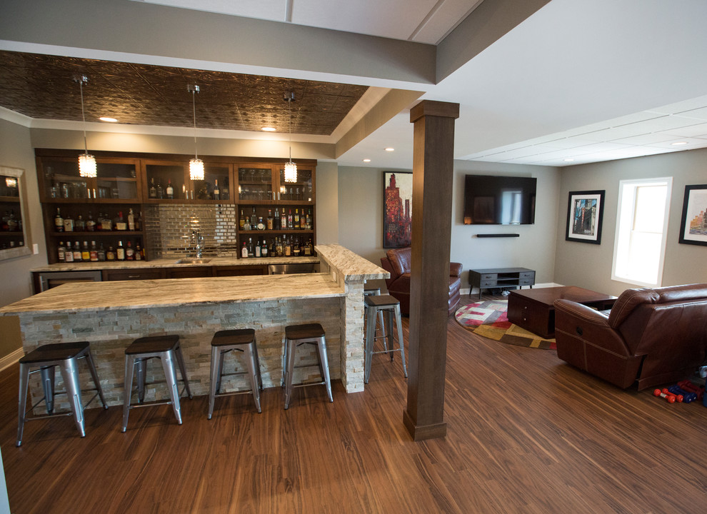 This is an example of a large eclectic walk-out basement in Chicago with vinyl floors and brown floor.