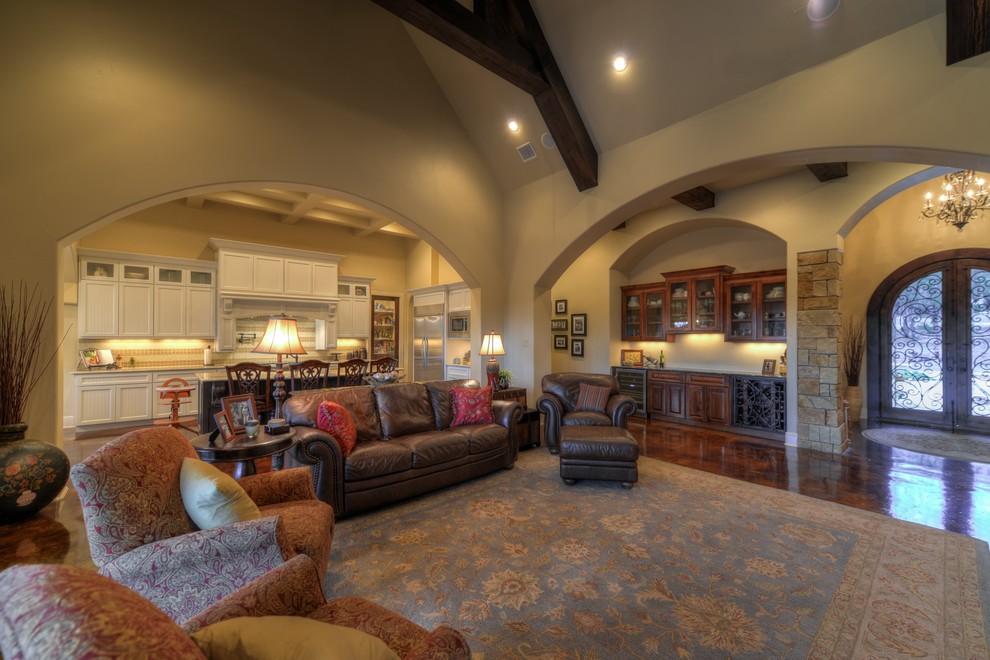 Inspiration for a large transitional formal open concept living room in Austin with beige walls, a standard fireplace, a stone fireplace surround and a freestanding tv.