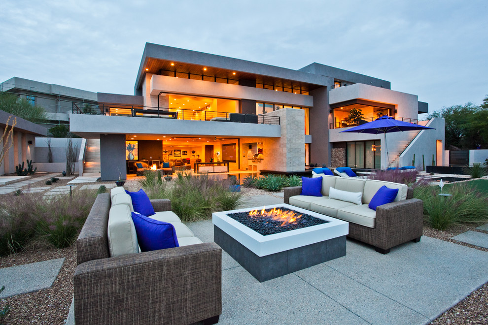 Contemporary backyard patio in Las Vegas with a fire feature, concrete slab and no cover.