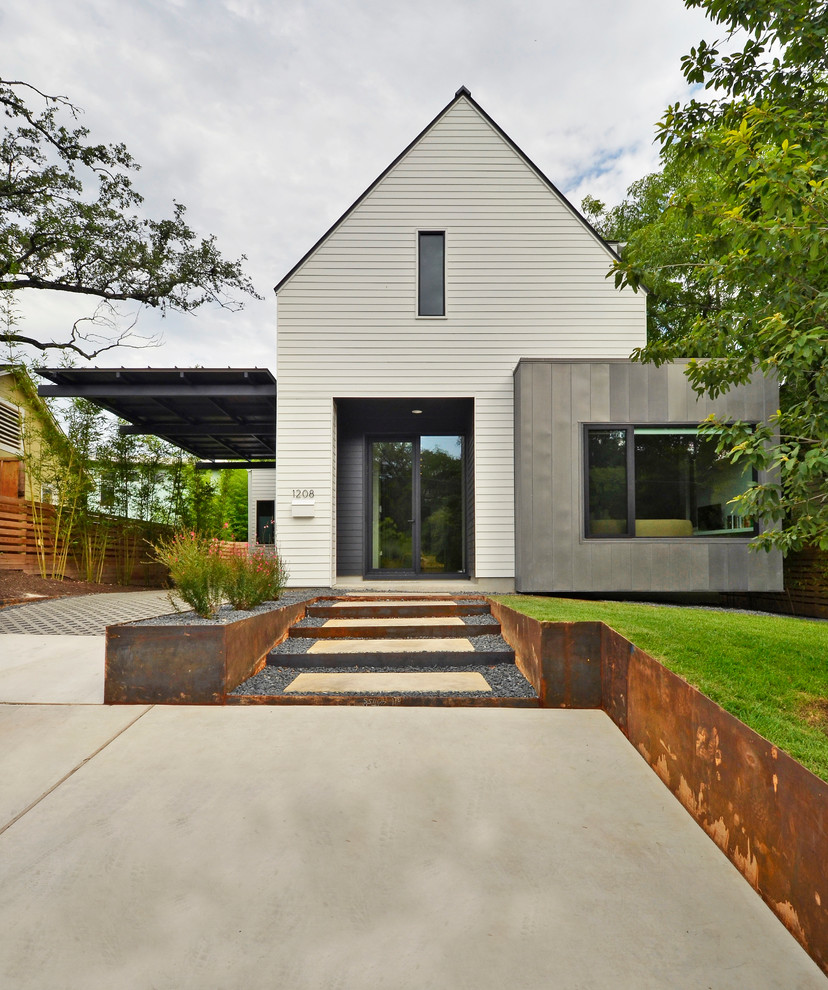 Photo of a contemporary two-storey white exterior in Austin with a gable roof.