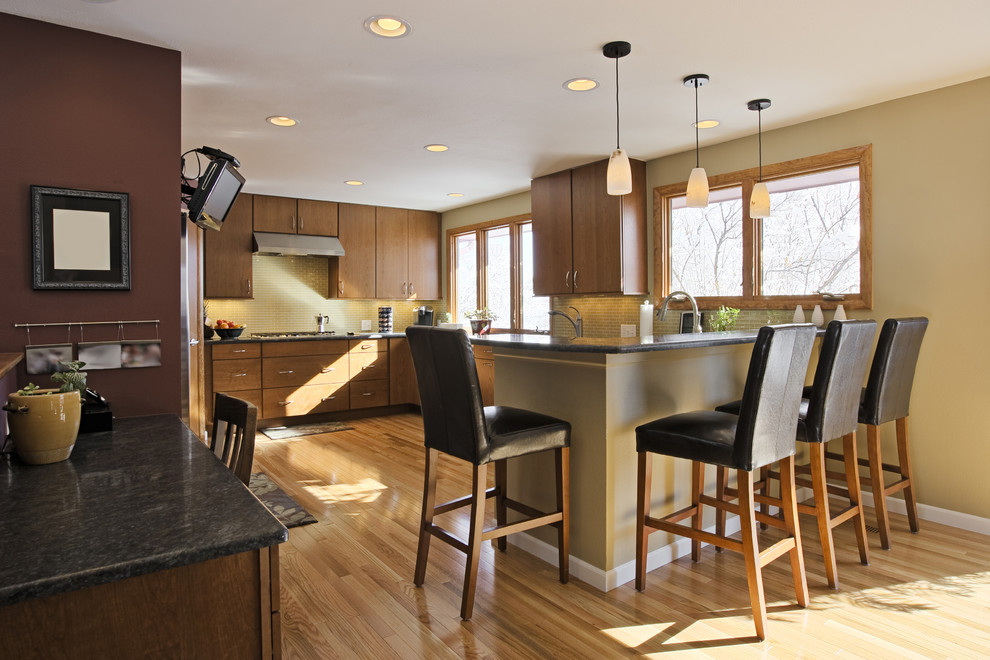 Eat-in kitchen - large light wood floor eat-in kitchen idea in Minneapolis with an undermount sink, medium tone wood cabinets, beige backsplash and stainless steel appliances