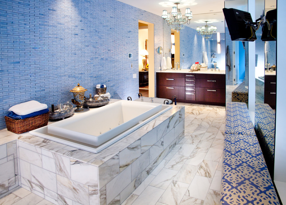 Photo of a bathroom in Chicago with flat-panel cabinets, dark wood cabinets, a drop-in tub, blue tile and mosaic tile.