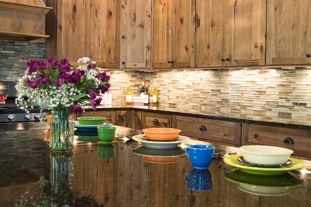 Inspiration for a rustic u-shaped beige floor eat-in kitchen remodel with shaker cabinets, brown cabinets, granite countertops, brown backsplash, stainless steel appliances, an island and gray countertops
