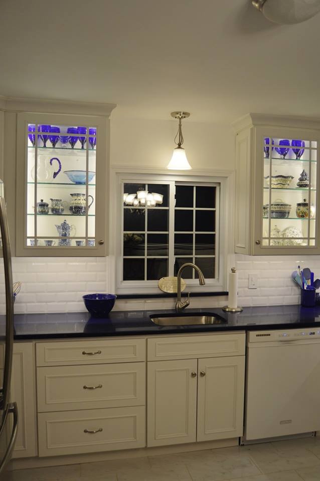 Large u-shaped porcelain tile eat-in kitchen photo in Boston with white cabinets, white backsplash, stainless steel appliances, an island, a single-bowl sink, recessed-panel cabinets, quartz countertops and cement tile backsplash