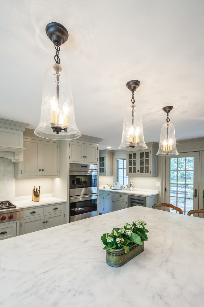 Example of a large transitional l-shaped dark wood floor kitchen design in Boston with a single-bowl sink, beaded inset cabinets, gray cabinets, marble countertops, gray backsplash, stone slab backsplash, paneled appliances and an island