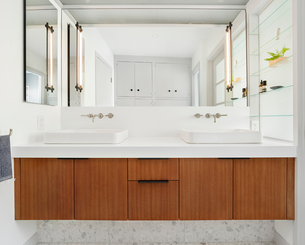 Photo of a midcentury master bathroom in Portland with flat-panel cabinets, medium wood cabinets, white walls, terrazzo floors, a vessel sink, engineered quartz benchtops, white floor and white benchtops.