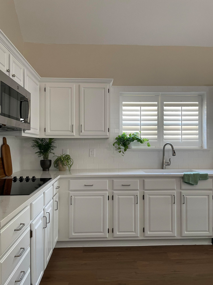 Kitchen - l-shaped kitchen idea with a single-bowl sink, white cabinets, white backsplash, subway tile backsplash, white countertops, quartz countertops, stainless steel appliances and an island