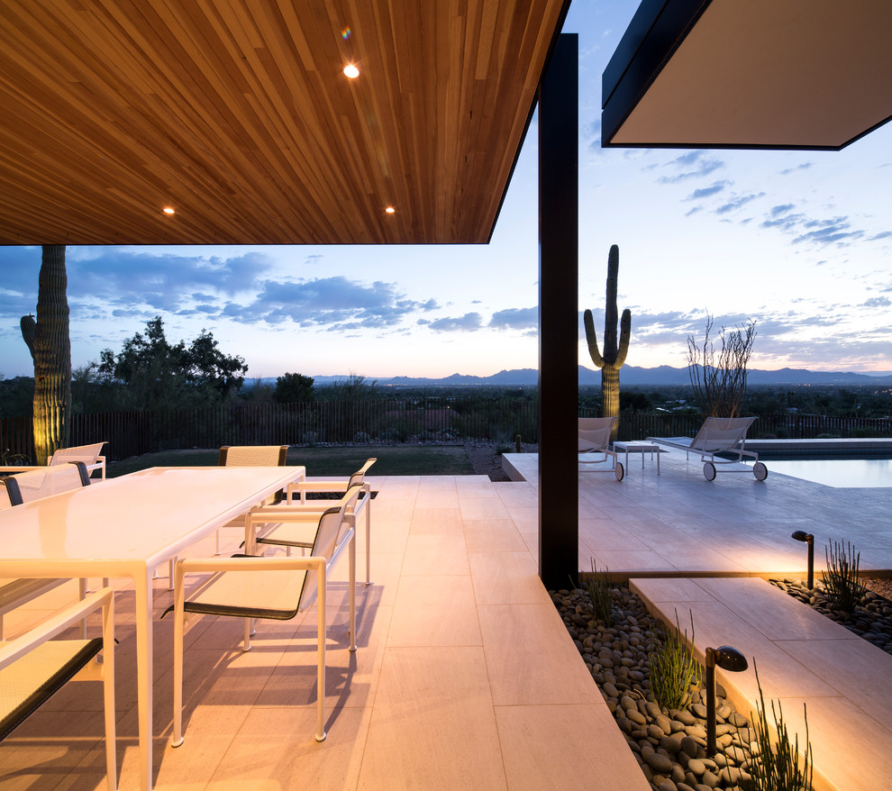 Inspiration for a contemporary patio in Phoenix with a roof extension.