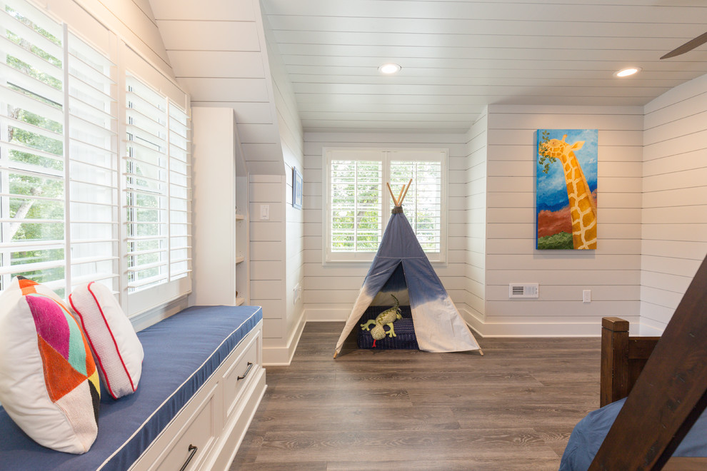 Photo of a large transitional kids' bedroom for kids 4-10 years old and boys in Charlotte with white walls and medium hardwood floors.