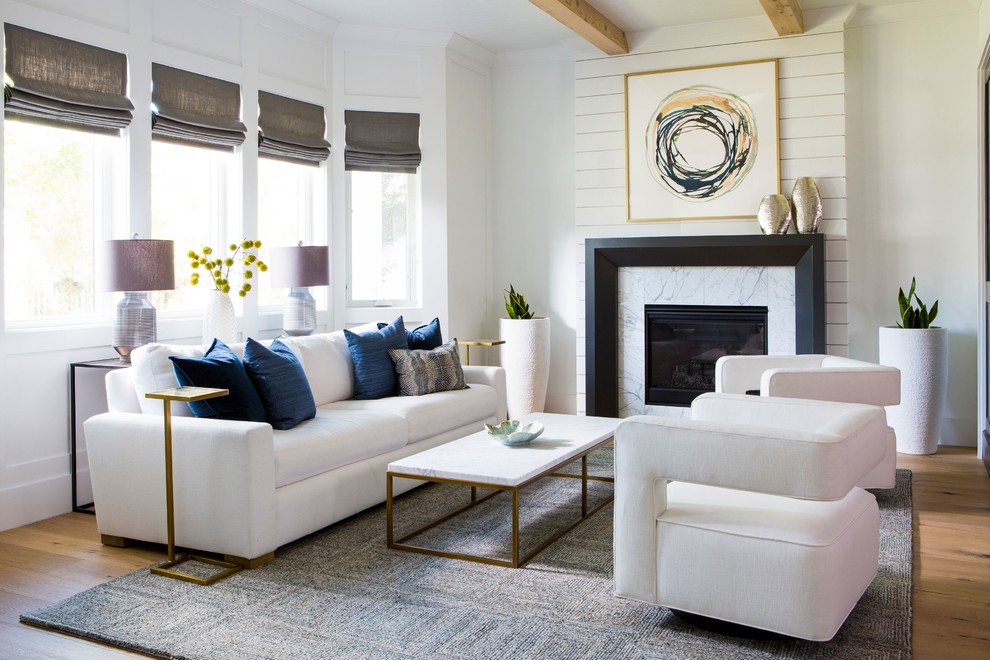 Inspiration for a transitional medium tone wood floor and brown floor living room remodel in Los Angeles with white walls and a standard fireplace