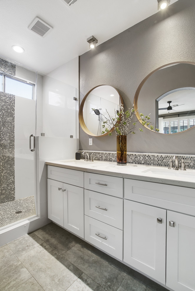 This is an example of a small transitional master bathroom in Las Vegas with shaker cabinets, white cabinets, an alcove shower, multi-coloured tile, mosaic tile, an undermount sink, grey floor, a hinged shower door, white benchtops, a double vanity and a built-in vanity.