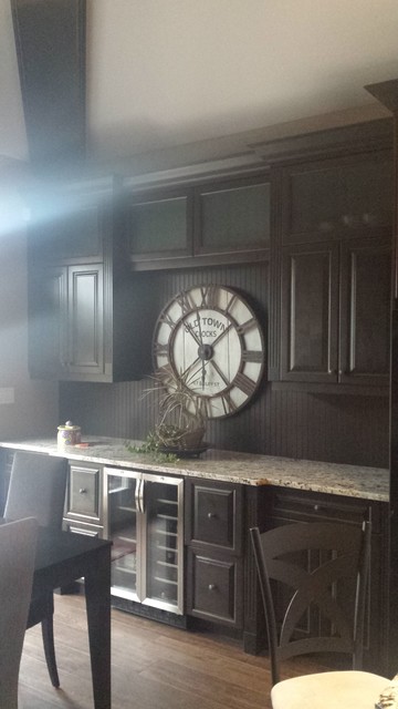 Kitchen - large rustic l-shaped medium tone wood floor kitchen idea in Other with an undermount sink, raised-panel cabinets, dark wood cabinets, granite countertops, multicolored backsplash, ceramic backsplash, stainless steel appliances and an island