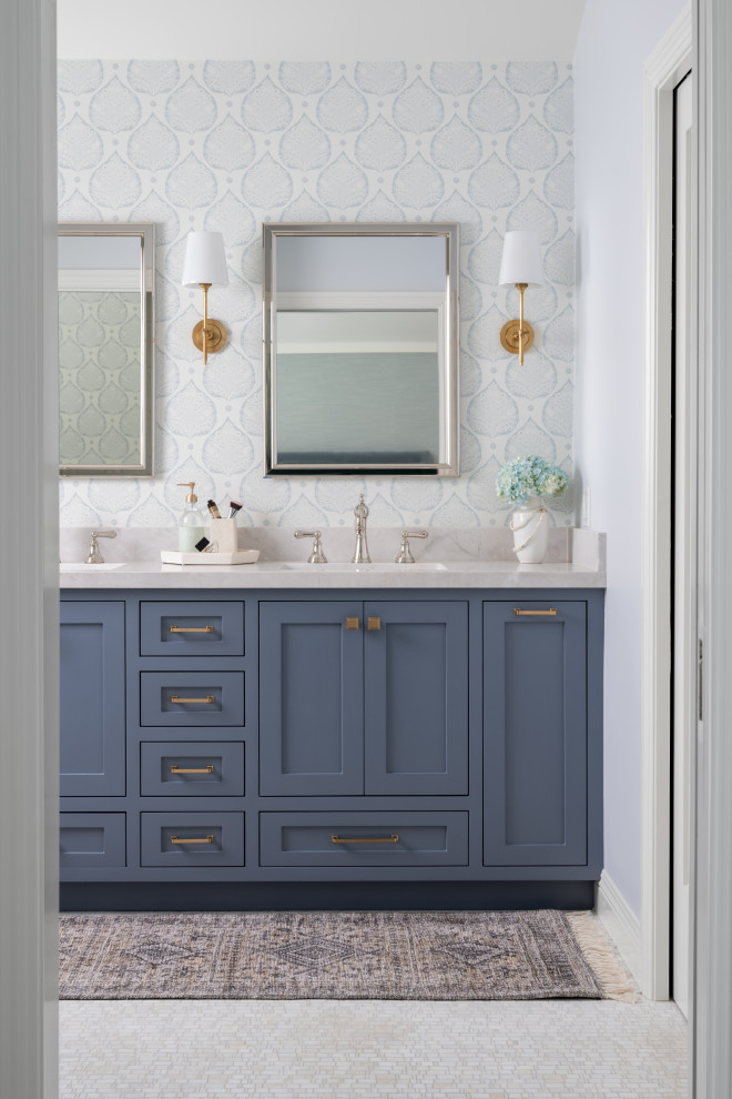 Design ideas for a large nautical ensuite bathroom in Orange County with shaker cabinets, blue cabinets, a freestanding bath, a corner shower, a one-piece toilet, grey tiles, ceramic tiles, blue walls, mosaic tile flooring, a submerged sink, quartz worktops, white floors, a hinged door, grey worktops, a wall niche, double sinks, a built in vanity unit, a vaulted ceiling and wallpapered walls.