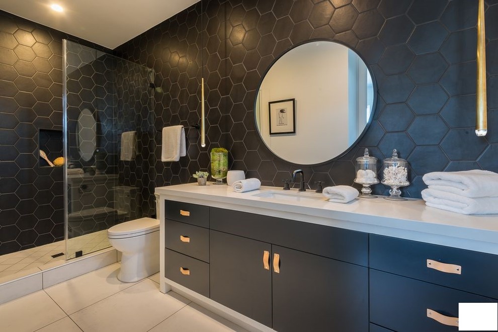 Mid-sized modern master bathroom in Los Angeles with flat-panel cabinets, black cabinets, an alcove shower, a one-piece toilet, black tile, ceramic tile, black walls, porcelain floors, an undermount sink, marble benchtops, white floor, a sliding shower screen and white benchtops.