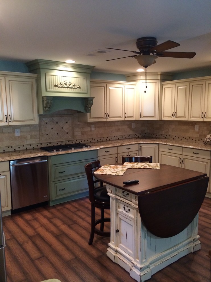 Inspiration for a mid-sized traditional u-shaped eat-in kitchen in Atlanta with a double-bowl sink, raised-panel cabinets, beige cabinets, granite benchtops, beige splashback, ceramic splashback, stainless steel appliances, medium hardwood floors and with island.