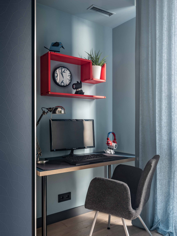 This is an example of a mid-sized scandinavian kids' room for boys in Moscow with blue walls.