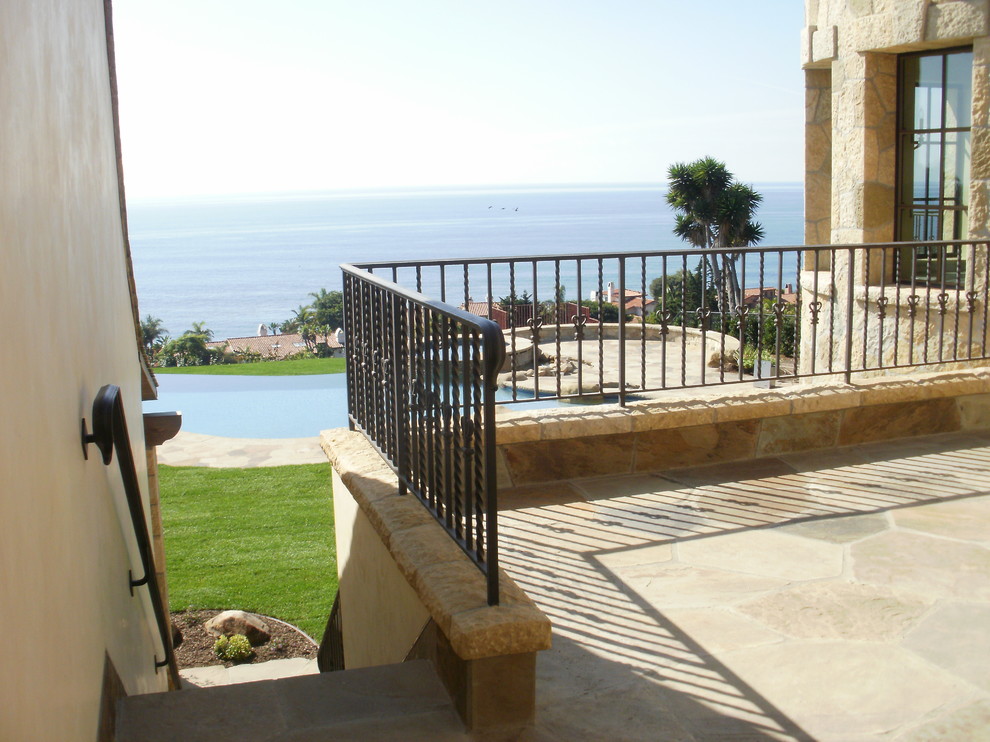 Mid-sized mediterranean backyard patio in Santa Barbara with natural stone pavers and no cover.
