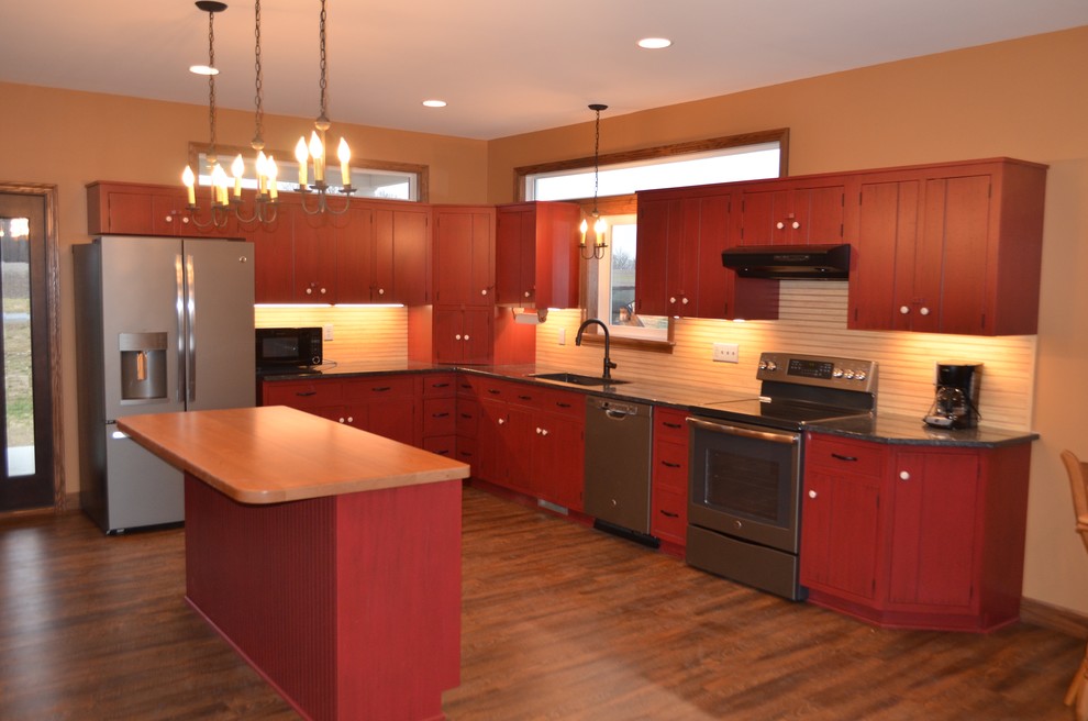 Inspiration for a large transitional l-shaped dark wood floor and brown floor eat-in kitchen remodel with an undermount sink, flat-panel cabinets, red cabinets, granite countertops, beige backsplash, stainless steel appliances and an island