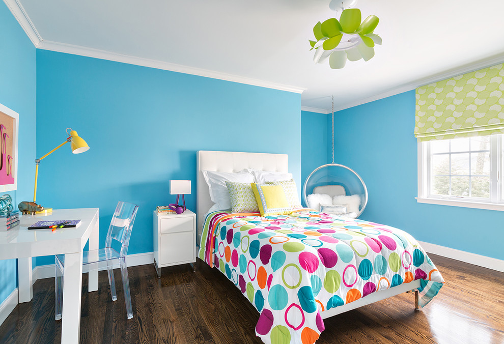 This is an example of a mid-sized contemporary kids' room for girls in New York with blue walls and dark hardwood floors.
