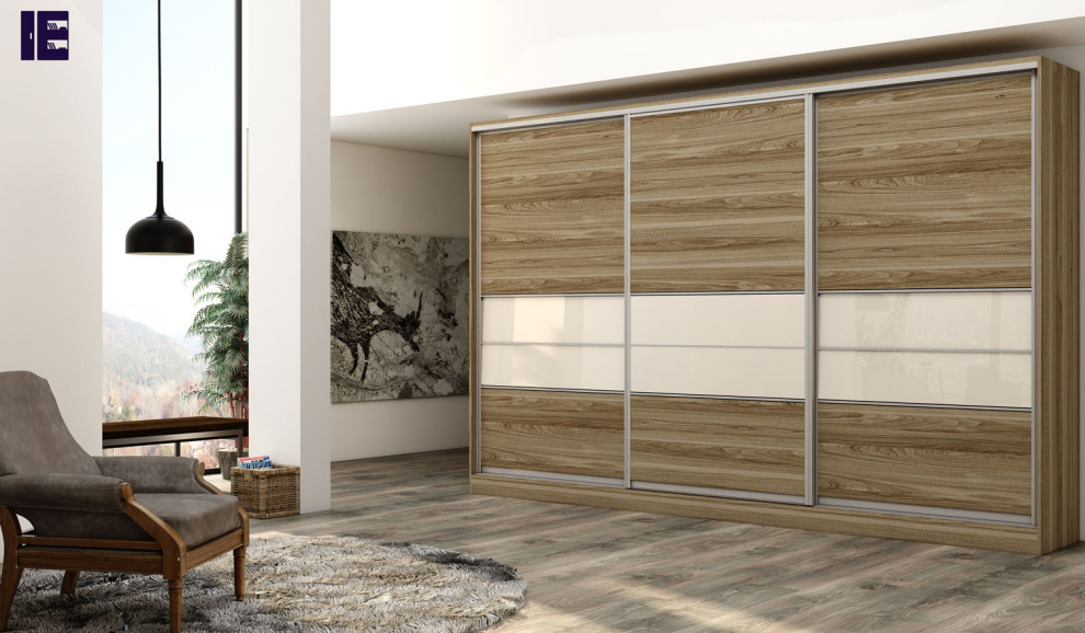 This is an example of a large contemporary storage and wardrobe in London with flat-panel cabinets and light wood cabinets.
