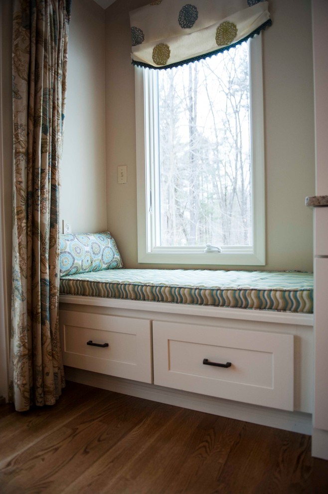 Example of a mid-sized transitional single-wall medium tone wood floor eat-in kitchen design in Boston with a single-bowl sink, recessed-panel cabinets, white cabinets, granite countertops, black backsplash, stainless steel appliances and an island