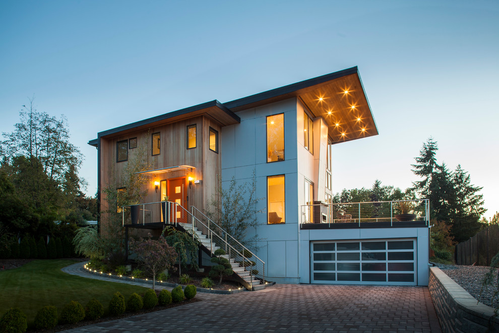 This is an example of a mid-sized contemporary three-storey exterior in Seattle with a shed roof and mixed siding.