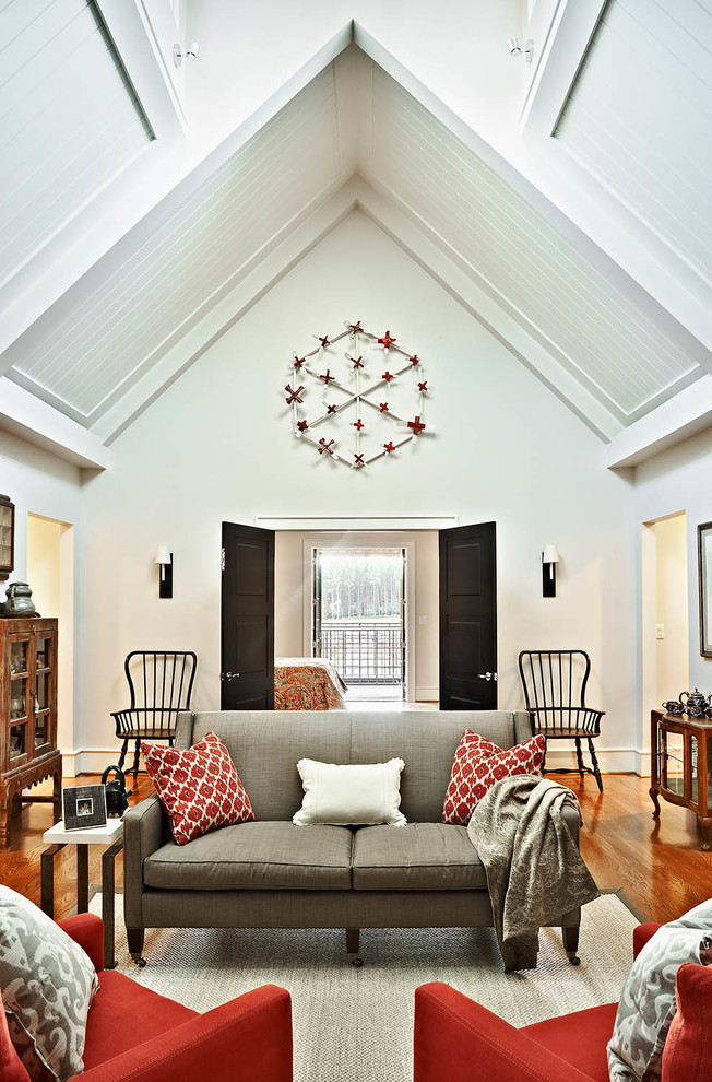 Photo of a transitional family room in Raleigh with white walls and medium hardwood floors.