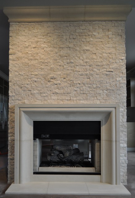 Cast limestone fireplace mantel with custom cast stone crown. Custom cast limestone fireplace surrounds