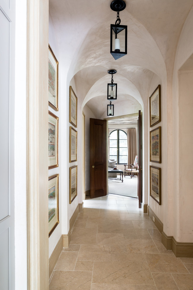 Inspiration for a mid-sized mediterranean hallway in DC Metro with white walls and travertine floors.