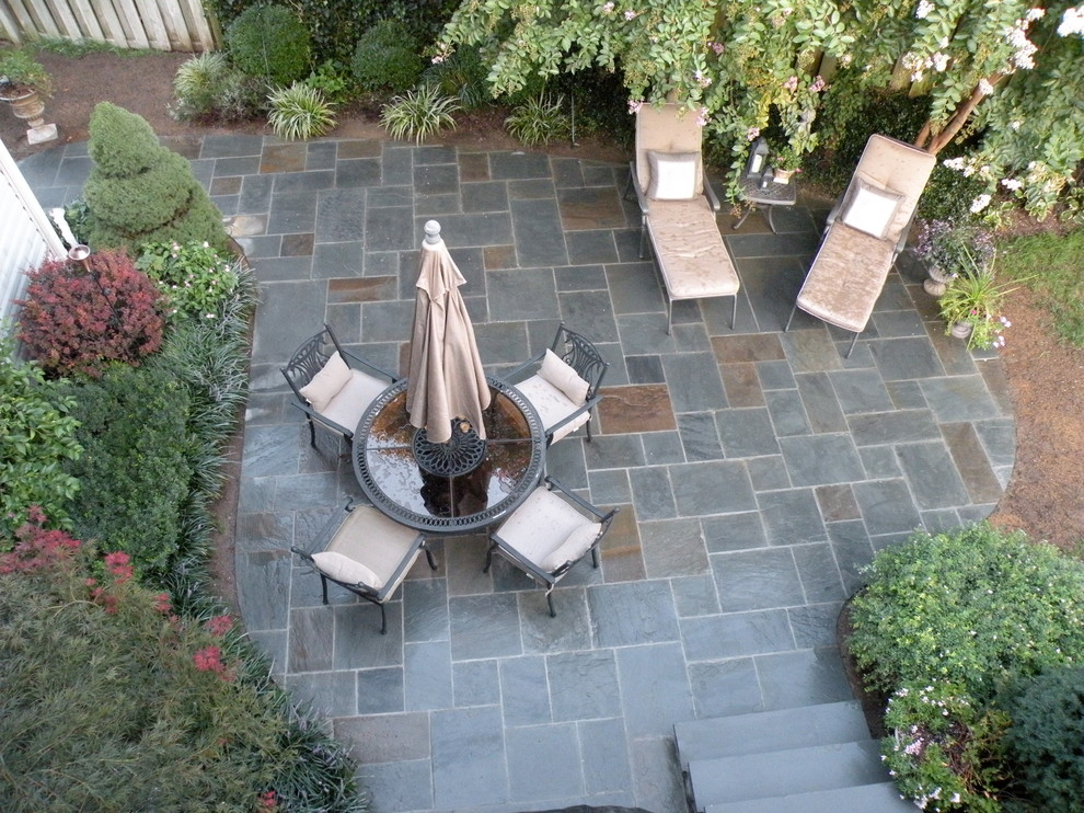Photo of a mid-sized traditional backyard patio in DC Metro with an outdoor kitchen, tile and no cover.