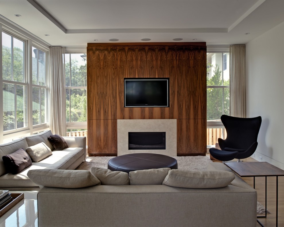 This is an example of a mid-sized contemporary enclosed family room in DC Metro with white walls, vinyl floors, a ribbon fireplace, a concrete fireplace surround and a built-in media wall.