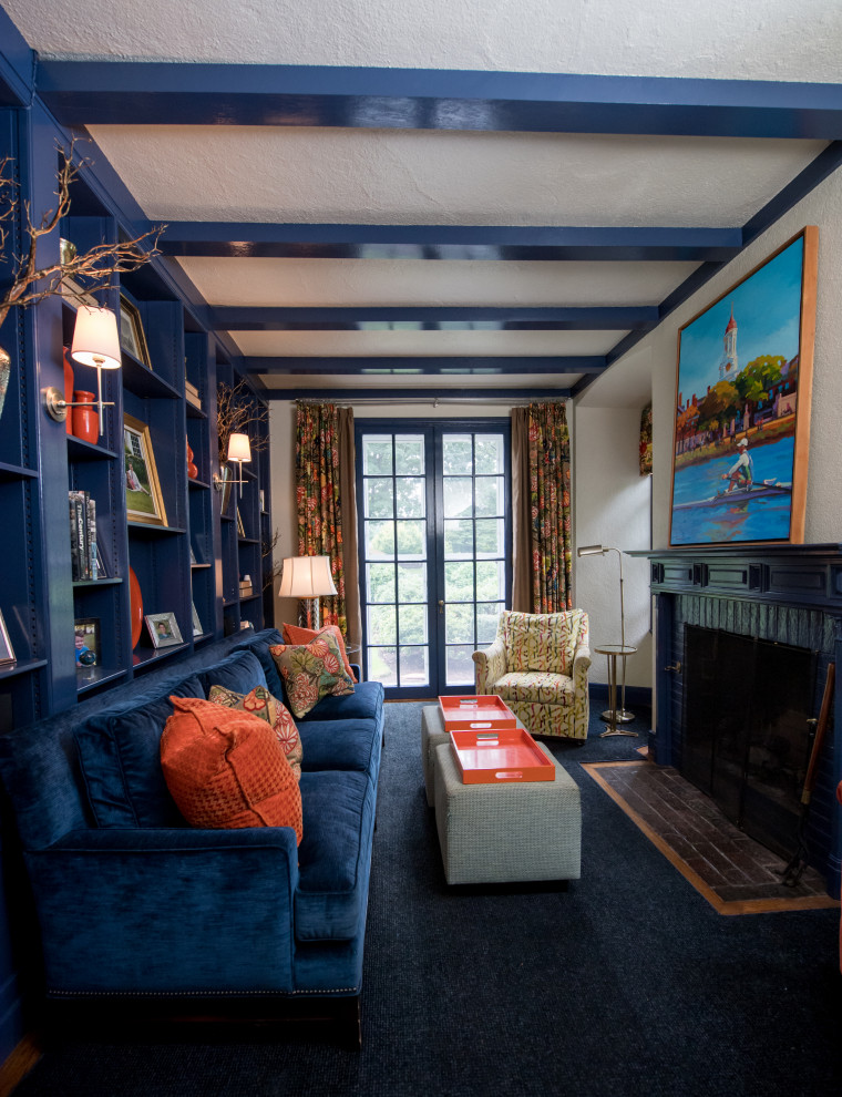 Mid-sized transitional home office in Boston with a library, white walls, carpet, a standard fireplace, a wood fireplace surround and blue floor.