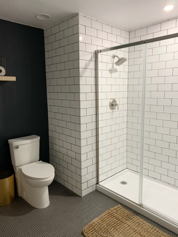 This is an example of a contemporary bathroom in Seattle with shaker cabinets, white cabinets, an alcove shower, a one-piece toilet, white tile, subway tile, blue walls, mosaic tile floors, a drop-in sink, quartzite benchtops, black floor, a sliding shower screen, black benchtops, a single vanity and a built-in vanity.