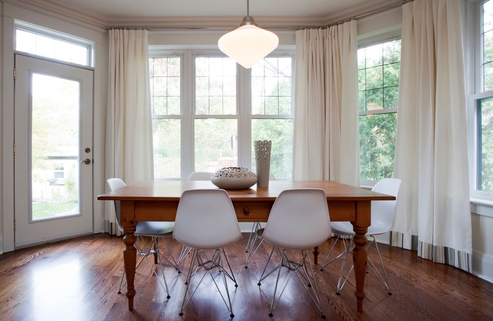 Inspiration for a modern dining room in Toronto with dark hardwood floors.