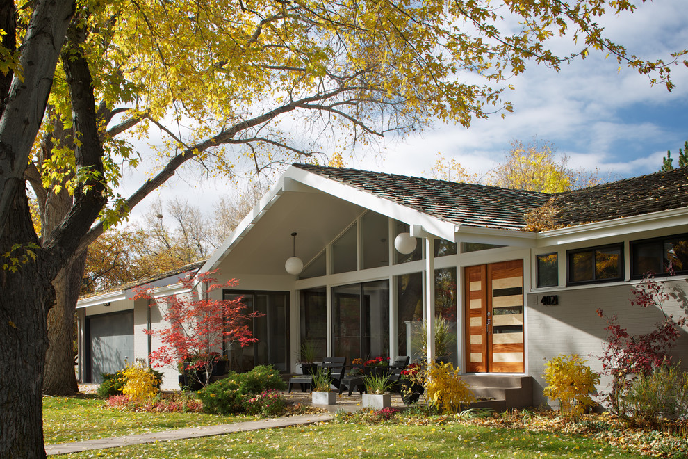Midcentury one-storey grey exterior in Denver with a gable roof.