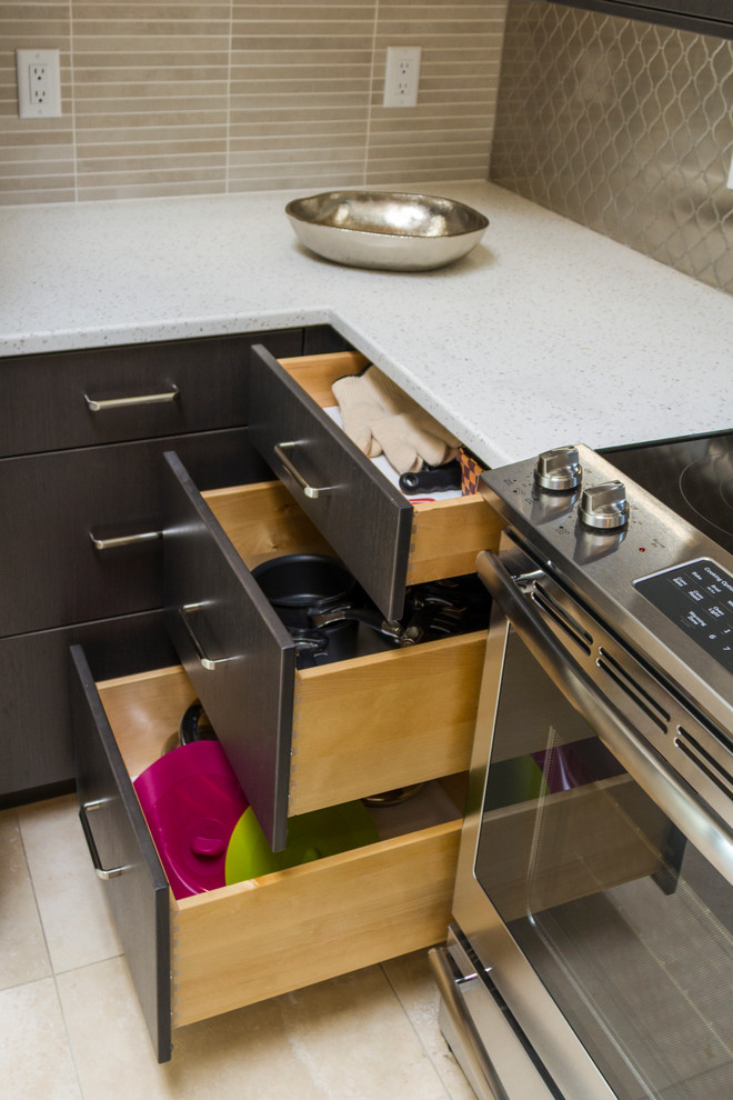 Photo of a mid-sized contemporary u-shaped separate kitchen in Phoenix with an undermount sink, flat-panel cabinets, dark wood cabinets, quartz benchtops, grey splashback, metal splashback, stainless steel appliances, travertine floors, a peninsula, beige floor and white benchtop.