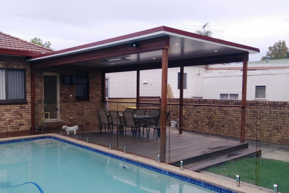 Mid-sized modern backyard deck in Sydney with a pergola.