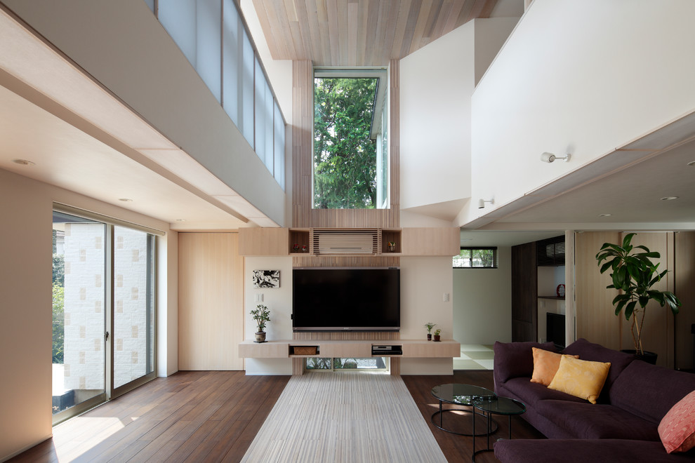 Large traditional formal open concept living room in Tokyo Suburbs with bamboo floors, a wall-mounted tv and white floor.