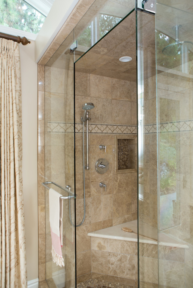 This is an example of a large contemporary master bathroom in Los Angeles with a double shower, beige tile, stone tile, beige walls and a hinged shower door.