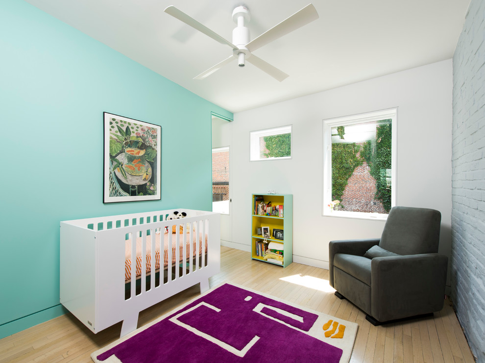 Nursery - mid-sized scandinavian gender-neutral light wood floor and beige floor nursery idea in DC Metro with blue walls