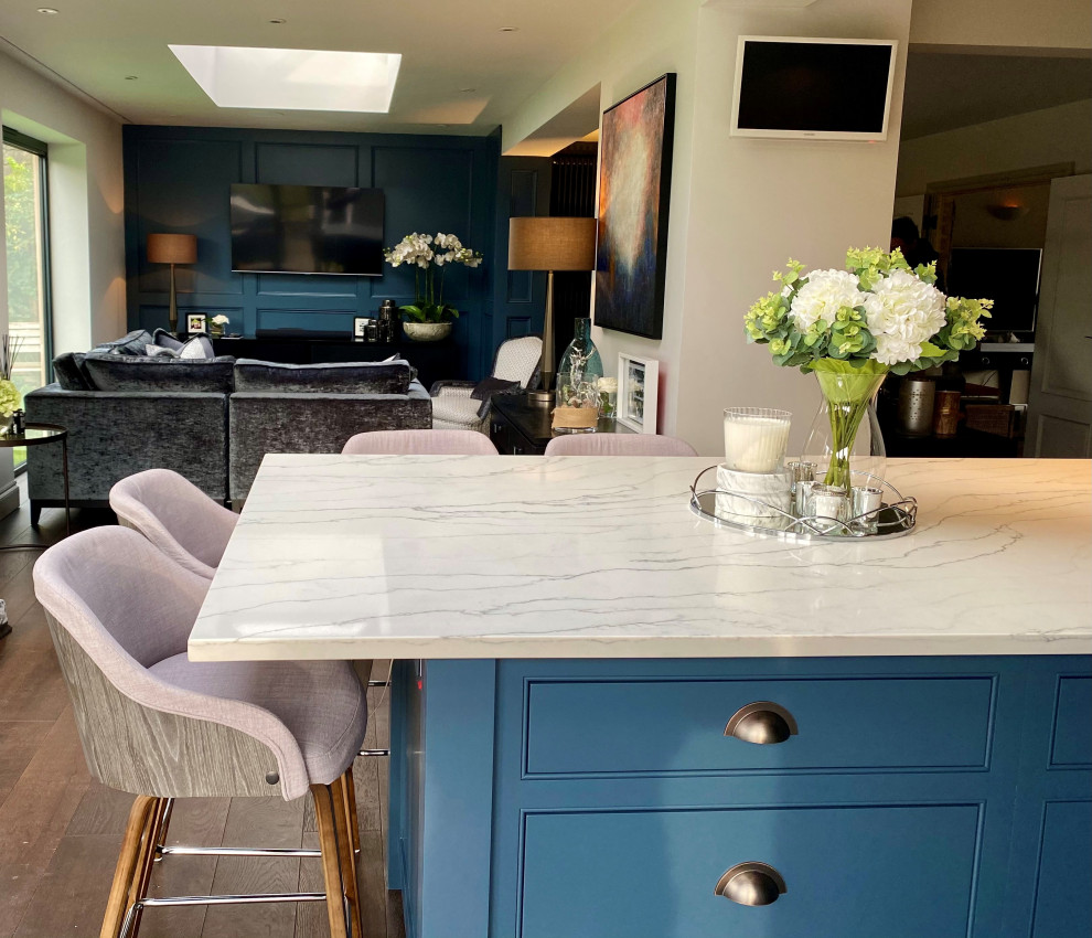 Dark blue kitchen island with white and integrated hob