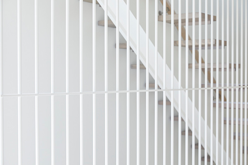 This is an example of a mid-sized contemporary wood straight staircase in Melbourne with open risers and wood railing.